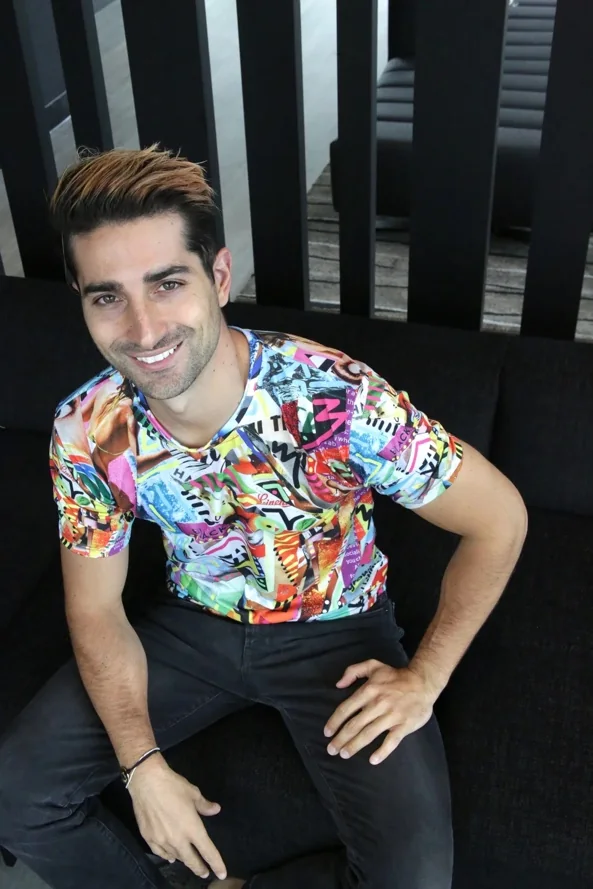 Artist Marco Santini wearing a colorful patterned shirt.